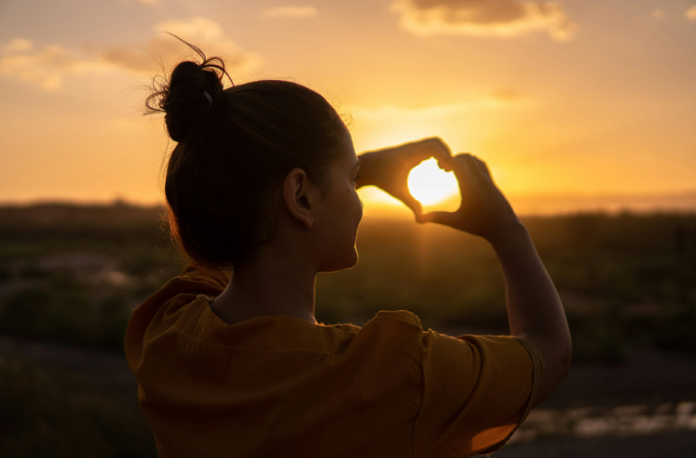 A woman enjoying the sun and living a joyful life.