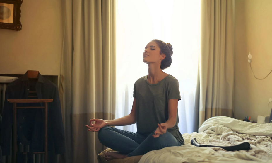 A woman practising meditation to improve her confidence and self-esteem.