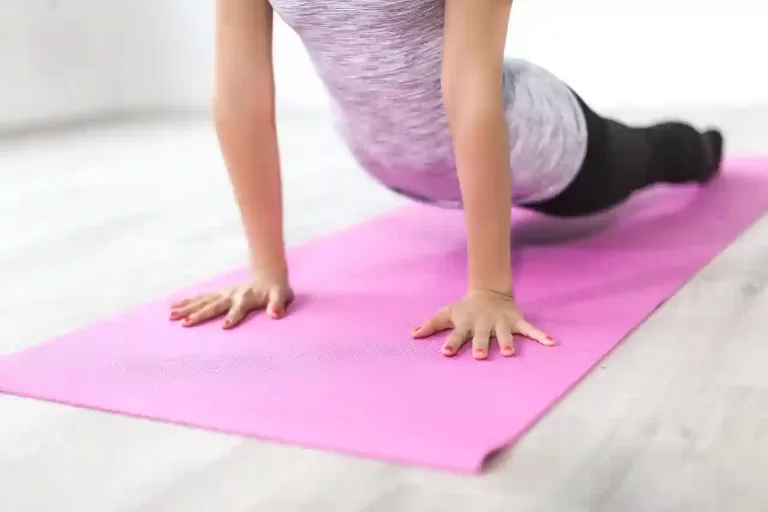 A woman performing physical activity on her mattress.