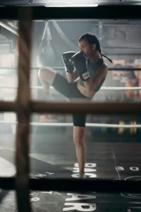 A woman performing boxing in the ring.