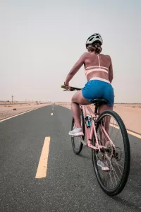 A woman riding a bicycle on the road.